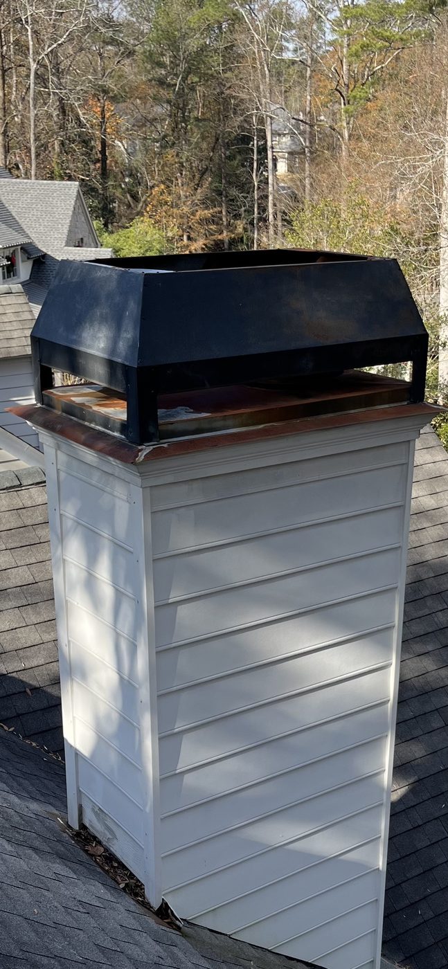Rusted rain pan on chimney cap